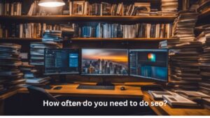 Laptops on the table, book shelves behind the laptops